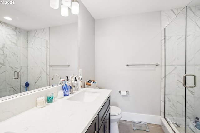 bathroom featuring tile patterned flooring, a shower with door, vanity, and toilet