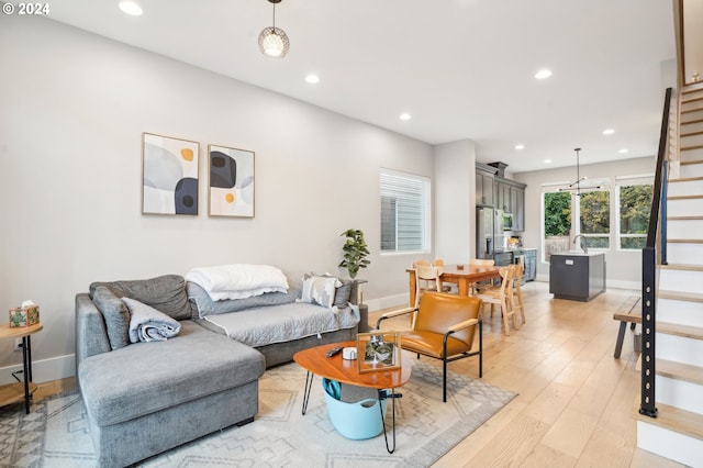 living room featuring light wood-type flooring and sink