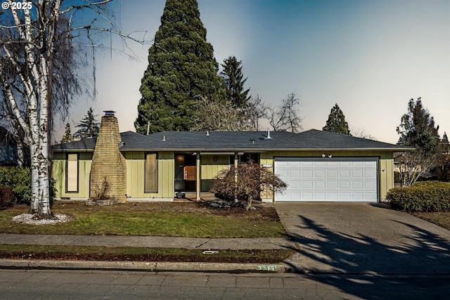 ranch-style home featuring a garage and a front yard