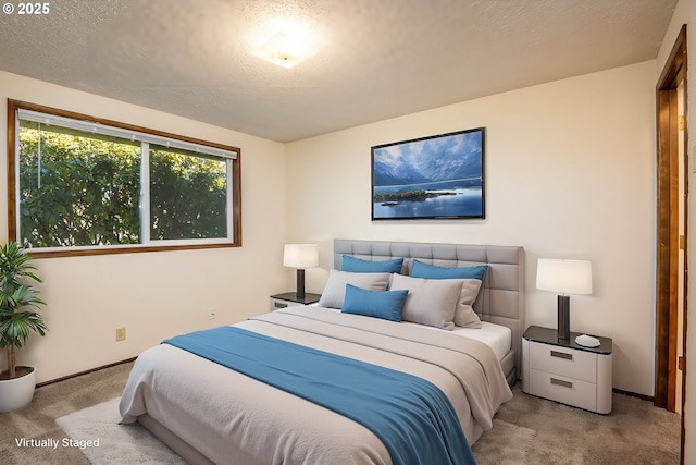 bedroom with light carpet and a textured ceiling