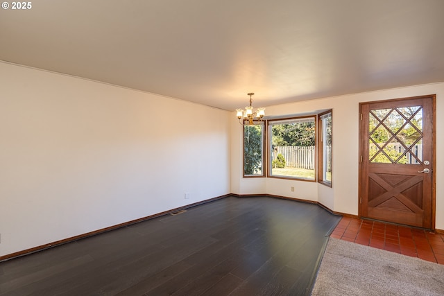 entrance foyer featuring dark hardwood / wood-style flooring and a notable chandelier