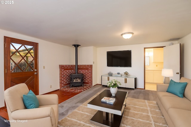 living room with a wood stove and hardwood / wood-style floors