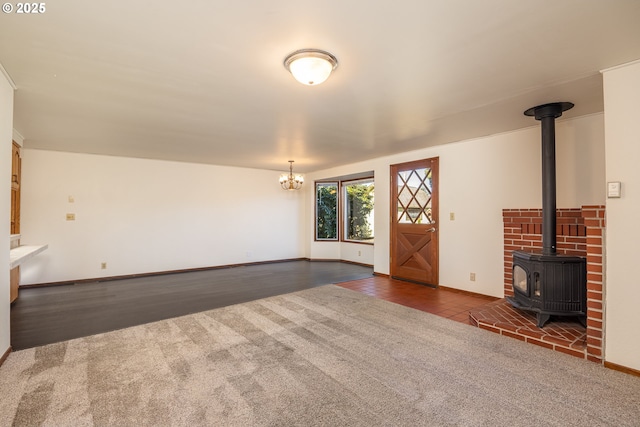 unfurnished living room featuring dark colored carpet and a wood stove