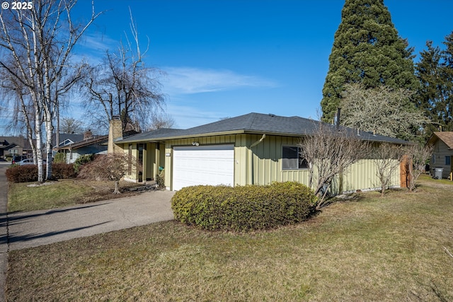 view of side of home featuring a yard and a garage