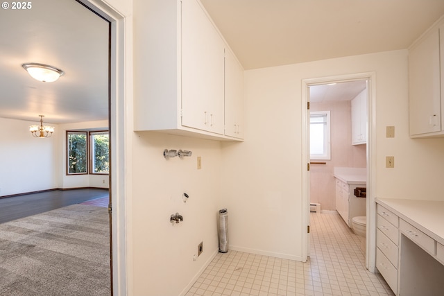 laundry area featuring cabinets and an inviting chandelier