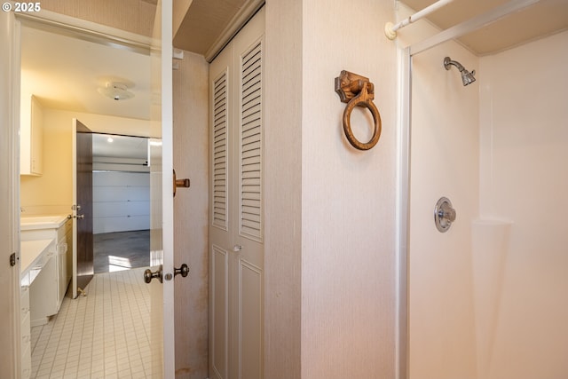 bathroom featuring vanity, tile patterned floors, and a shower