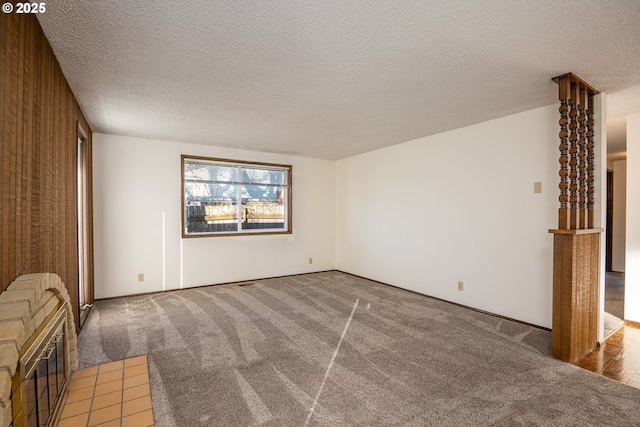 interior space featuring a textured ceiling and carpet flooring