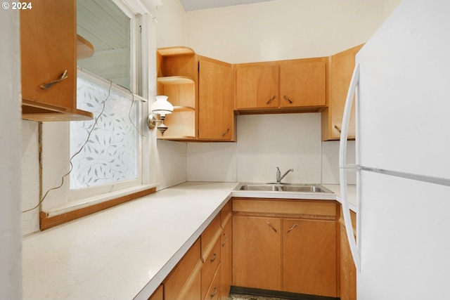 kitchen featuring white refrigerator and sink