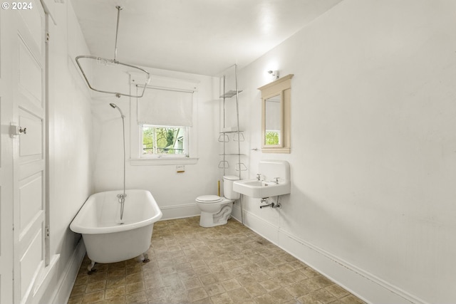 bathroom featuring sink, tile floors, and toilet