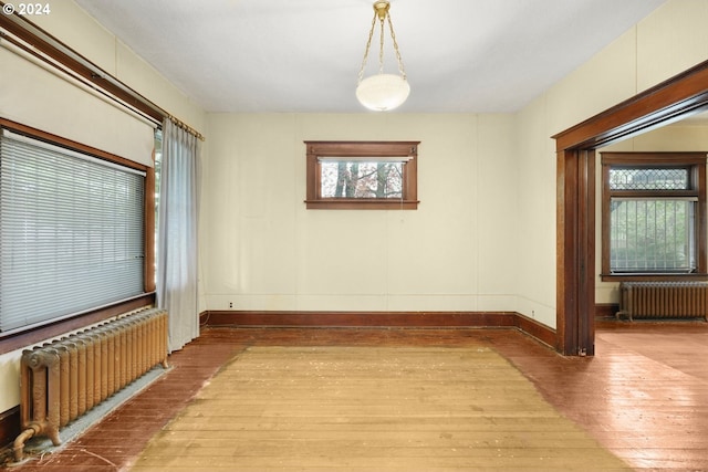 interior space with radiator heating unit and hardwood / wood-style floors