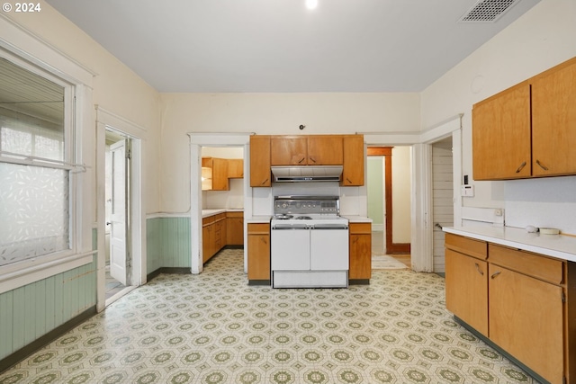 kitchen with double oven range and light tile floors