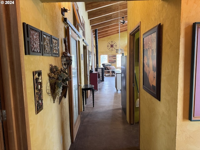 44 Justanother Rd, Goldendale, WA 98620 - hallway with a textured wall, concrete floors, a barn door, and wood ceiling