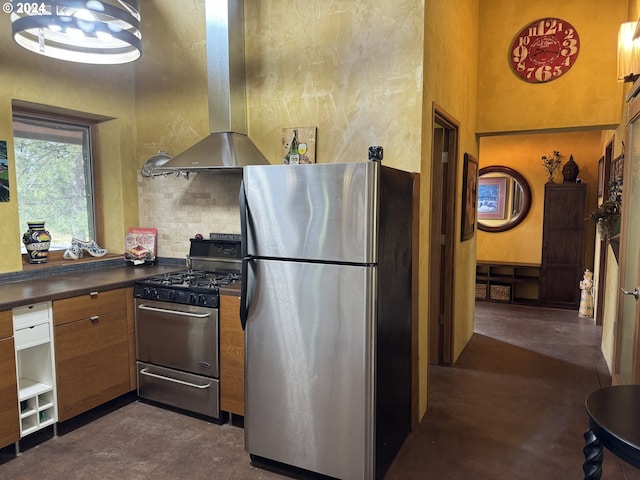 44 Justanother Rd, Goldendale, WA 98620 - kitchen with stainless steel appliances, island exhaust hood, finished concrete floors, brown cabinets, and dark countertops