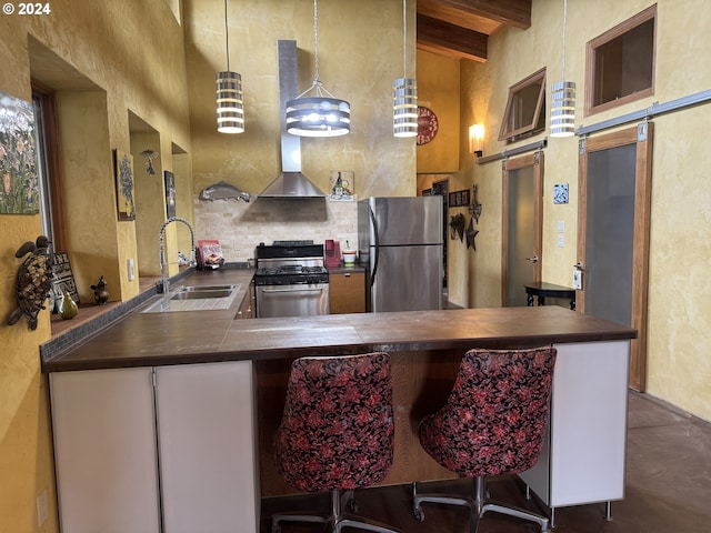 44 Justanother Rd, Goldendale, WA 98620 - kitchen with stainless steel appliances, a sink, wall chimney range hood, beam ceiling, and finished concrete flooring