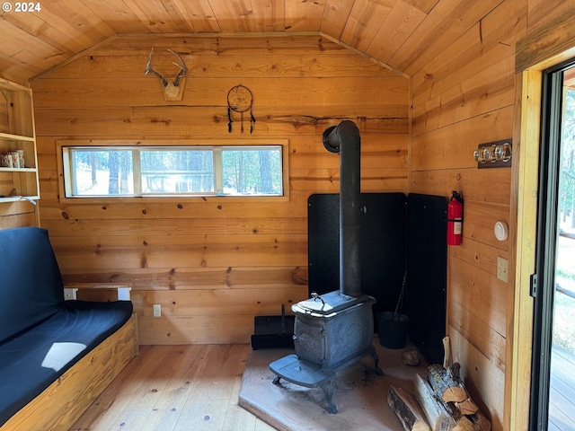 44 Justanother Rd, Goldendale, WA 98620 - sitting room featuring lofted ceiling, a wood stove, wood walls, wooden ceiling, and healthy amount of natural light