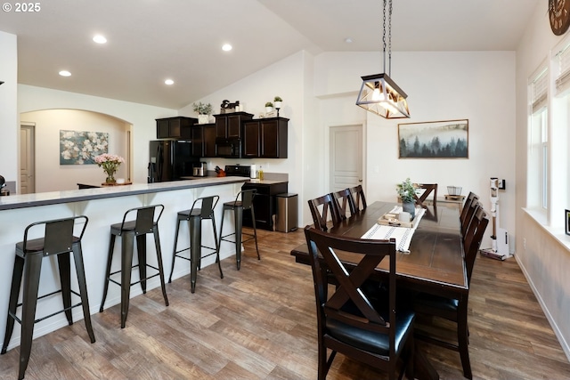 27309 8th St, Junction City, OR 97448 - dining area featuring recessed lighting, arched walkways, lofted ceiling, and wood finished floors