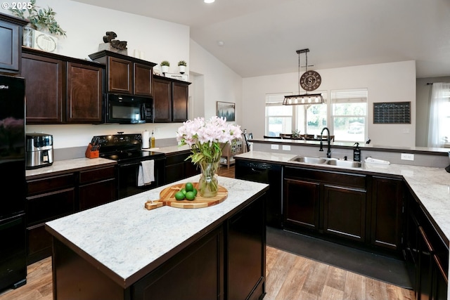 27309 8th St, Junction City, OR 97448 - kitchen featuring light wood-type flooring, black appliances, a center island, a sink, and lofted ceiling