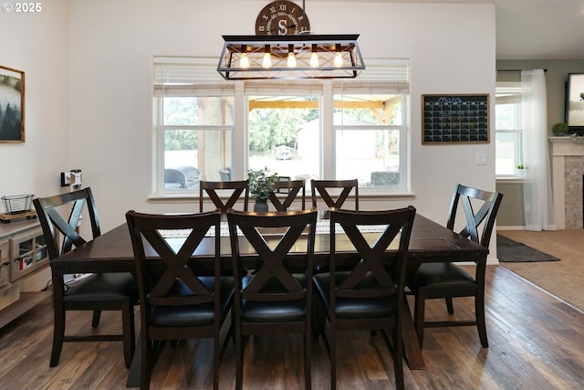 27309 8th St, Junction City, OR 97448 - dining space featuring a chandelier, dark wood-style flooring, baseboards, and plenty of natural light