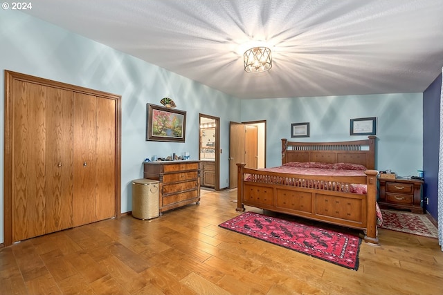 bedroom with a closet and light hardwood / wood-style floors