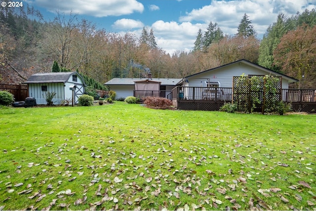 view of yard with a storage unit and a wooden deck