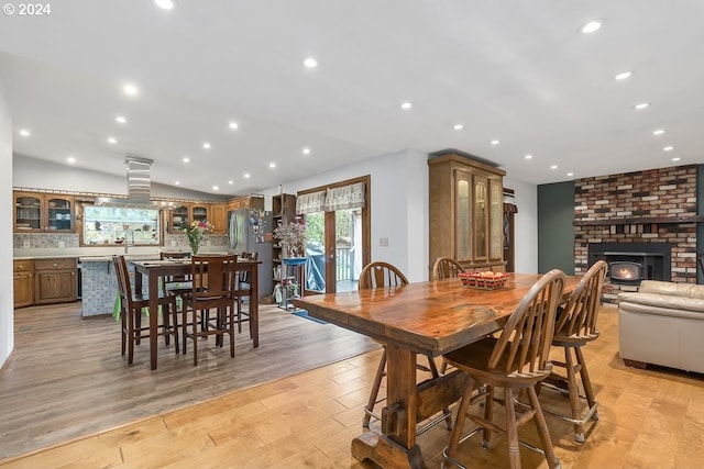 dining room featuring light wood-type flooring and a wood stove