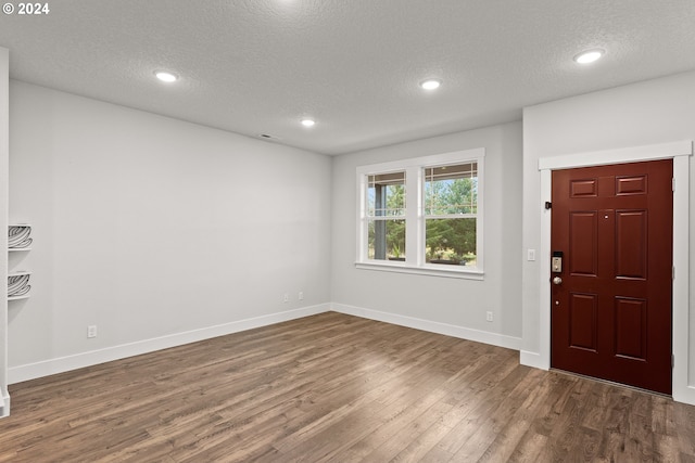 foyer with a textured ceiling and dark wood-type flooring