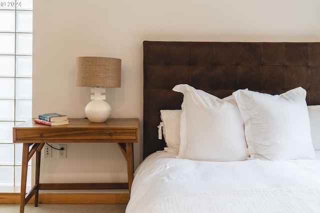 carpeted bedroom with multiple windows