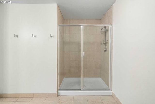 bathroom with tile patterned floors and an enclosed shower