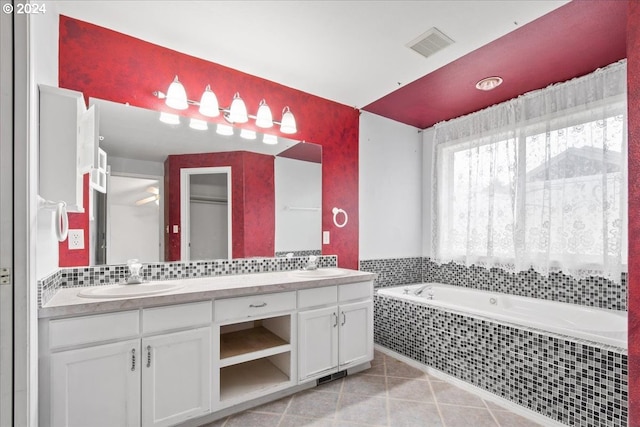 bathroom featuring vanity and tiled tub