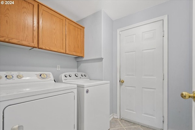 washroom with cabinets and washing machine and dryer