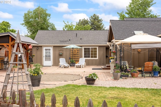 rear view of property featuring a gazebo and a patio area