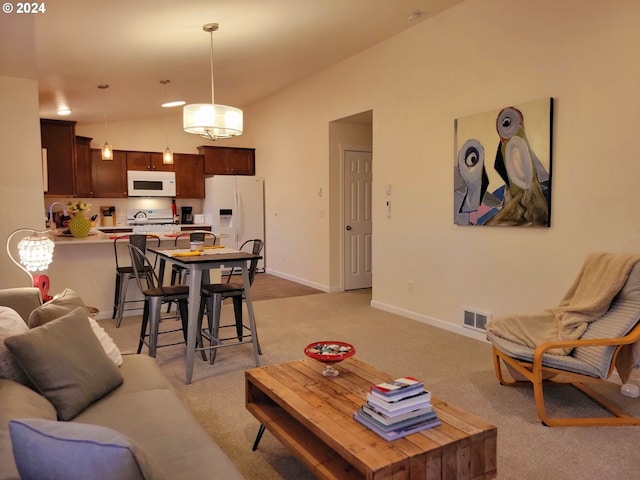 living room with light colored carpet and vaulted ceiling