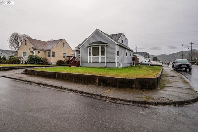 view of front of house with a residential view and a front lawn