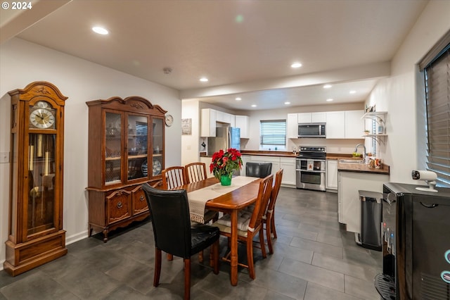 dining area with dark tile patterned flooring and recessed lighting