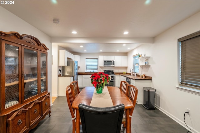 dining room featuring recessed lighting and baseboards