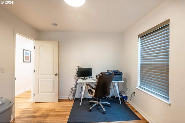 office with light wood-style flooring and baseboards