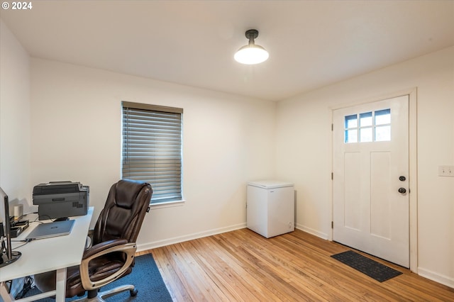 office space featuring light wood-style floors and baseboards