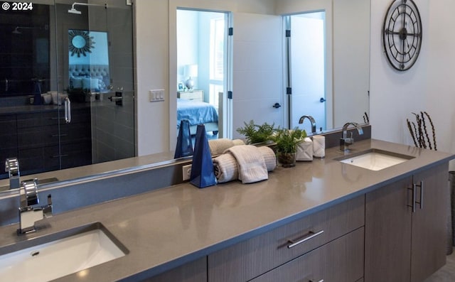 bathroom with a shower with door and vanity