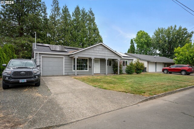 ranch-style home featuring a garage and a front yard