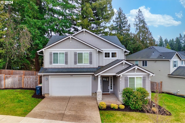 craftsman inspired home with a front yard and a garage