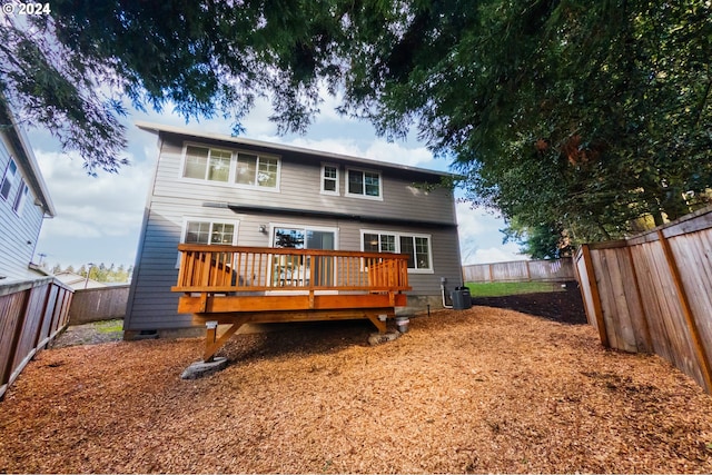 back of property with a deck and central air condition unit