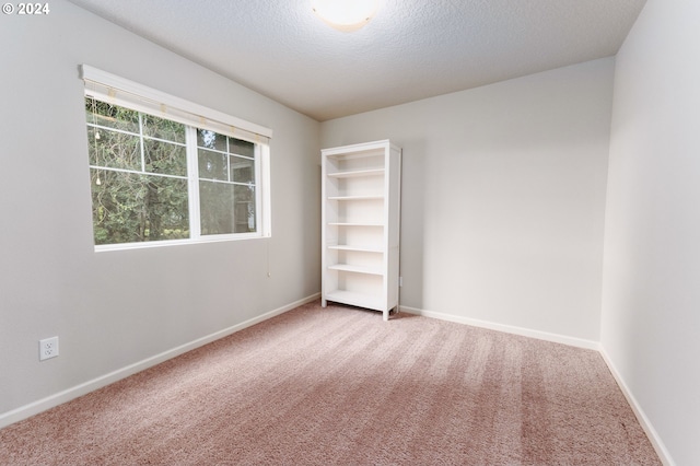 unfurnished bedroom featuring carpet floors and a textured ceiling