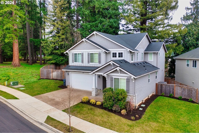 craftsman house featuring a garage and a front lawn