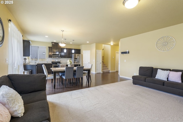 living room with dark hardwood / wood-style flooring and sink