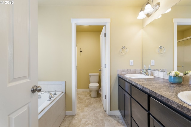 bathroom with toilet, vanity, and tiled bath