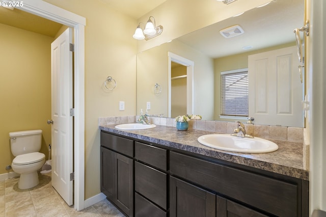 bathroom with vanity, tile patterned floors, and toilet