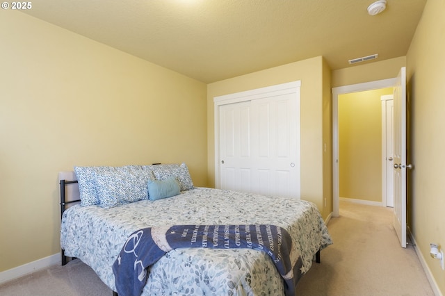 carpeted bedroom featuring a closet