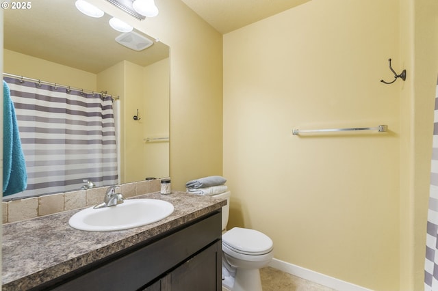 bathroom with vanity, tile patterned flooring, and toilet