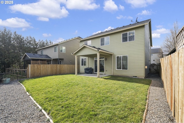 back of property featuring a lawn and a patio area