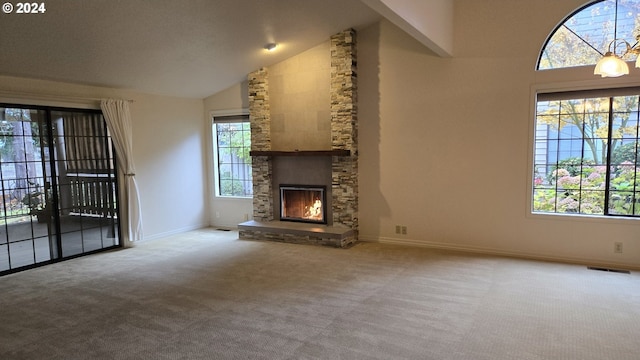 unfurnished living room featuring a fireplace, carpet floors, high vaulted ceiling, and plenty of natural light